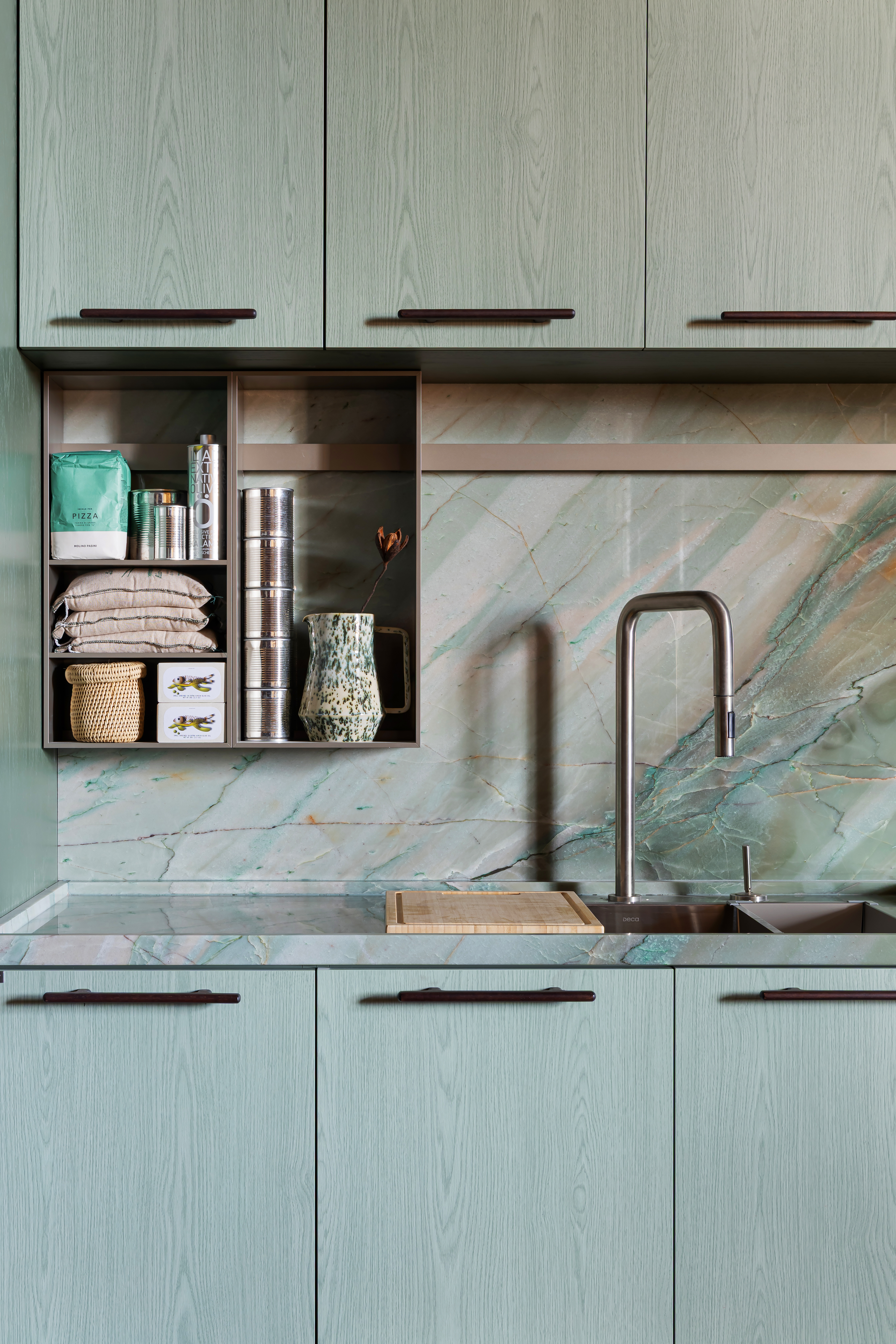close up of kitchen with veined marble style splashback
