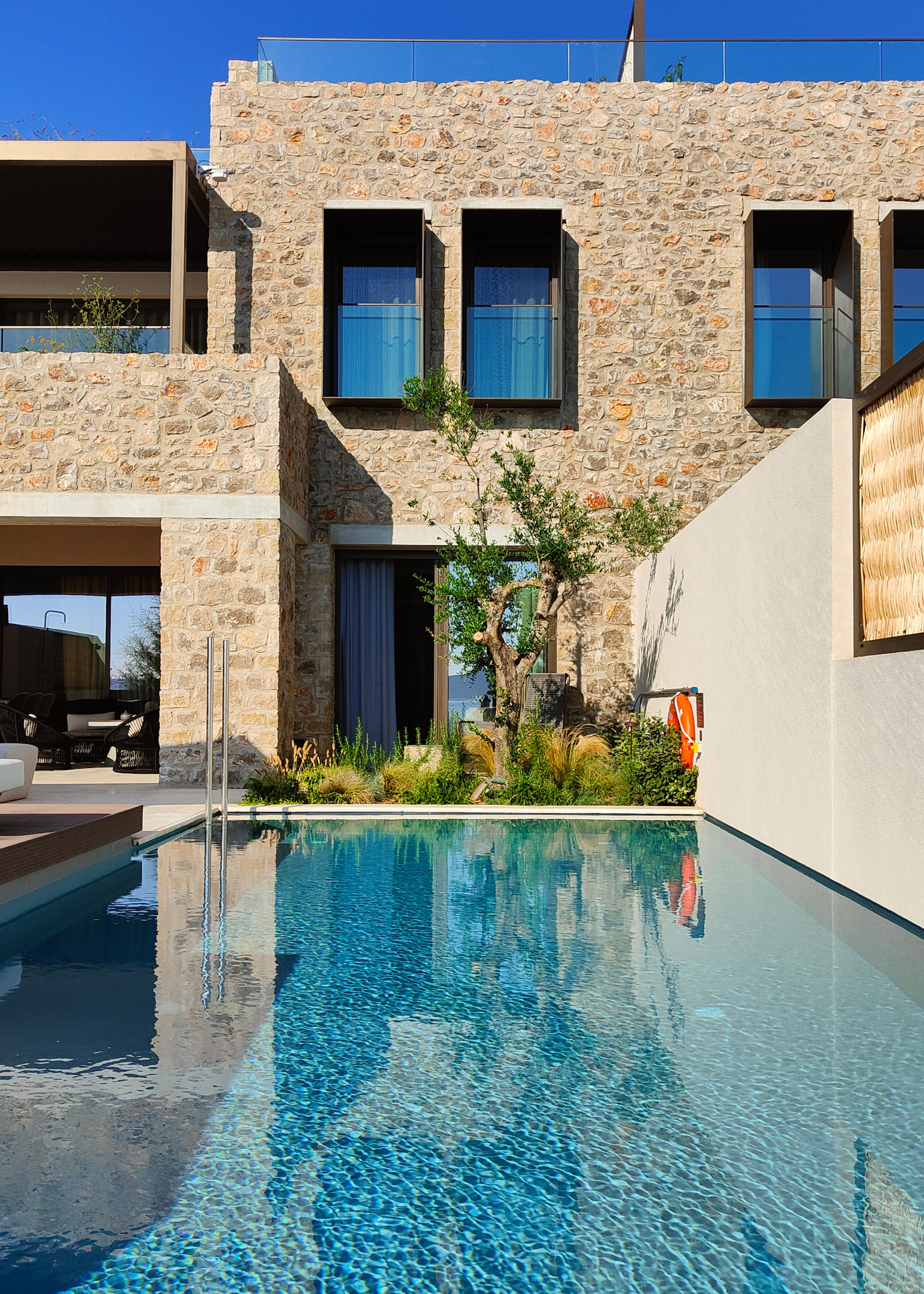 A long swimming pool in a Greek garden