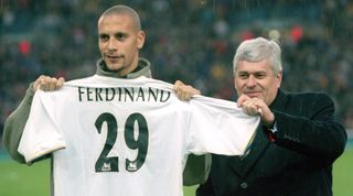 26 Nov 2000: Leeds United record signing Rio Ferdinand receives his new shirt from Leeds United chairman Peter Risdale before the FA Carling Premiership match played at Elland Road, in Leeds, England