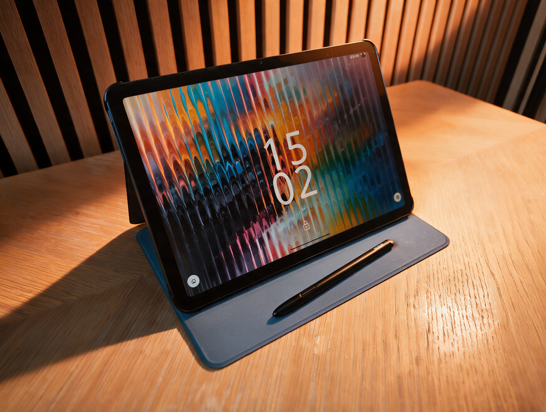 A black Android drawing tablet on a wooden table