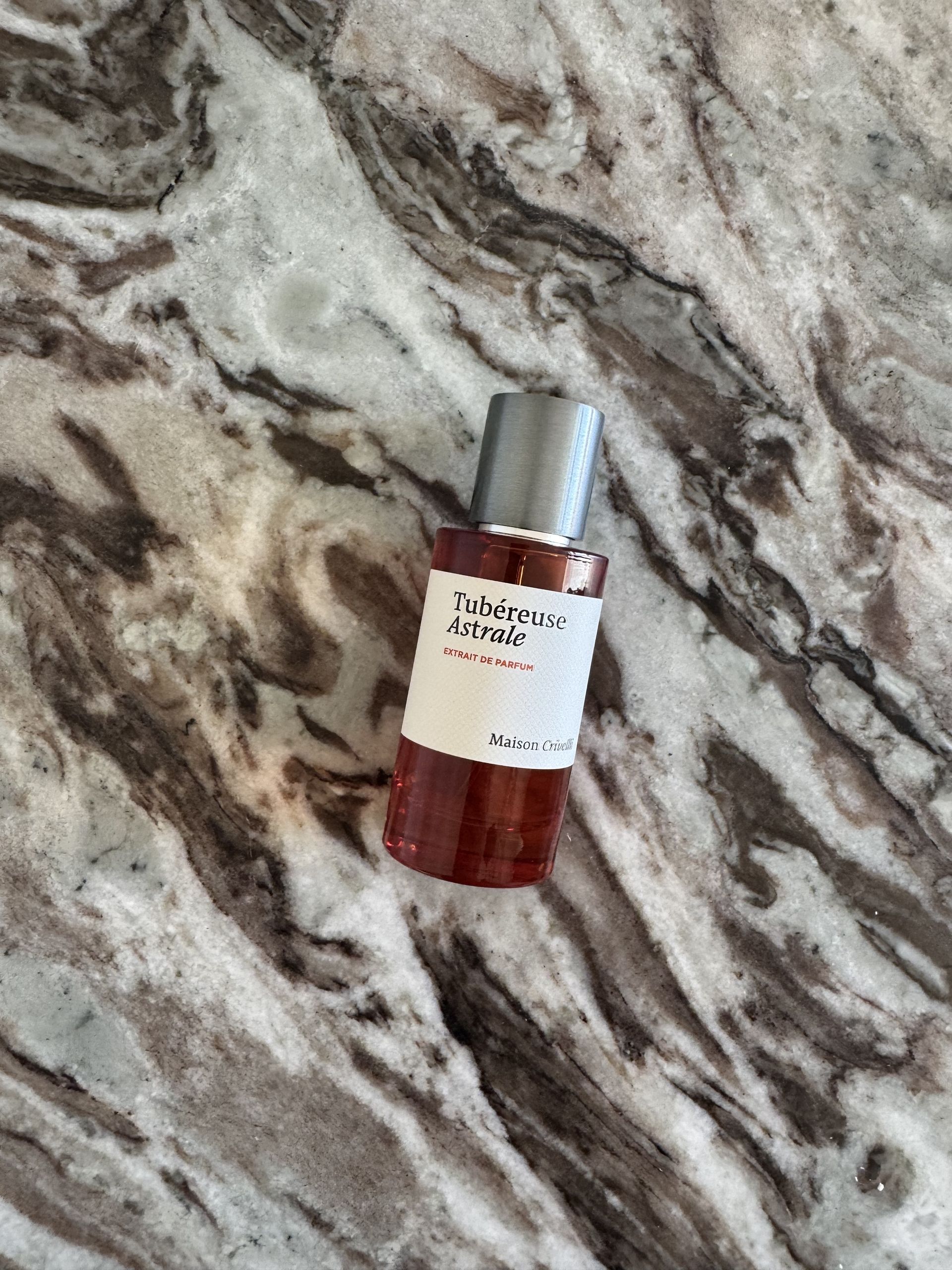 A bottle of Maison Crivelli Tubéreuse Astrale on a marble table