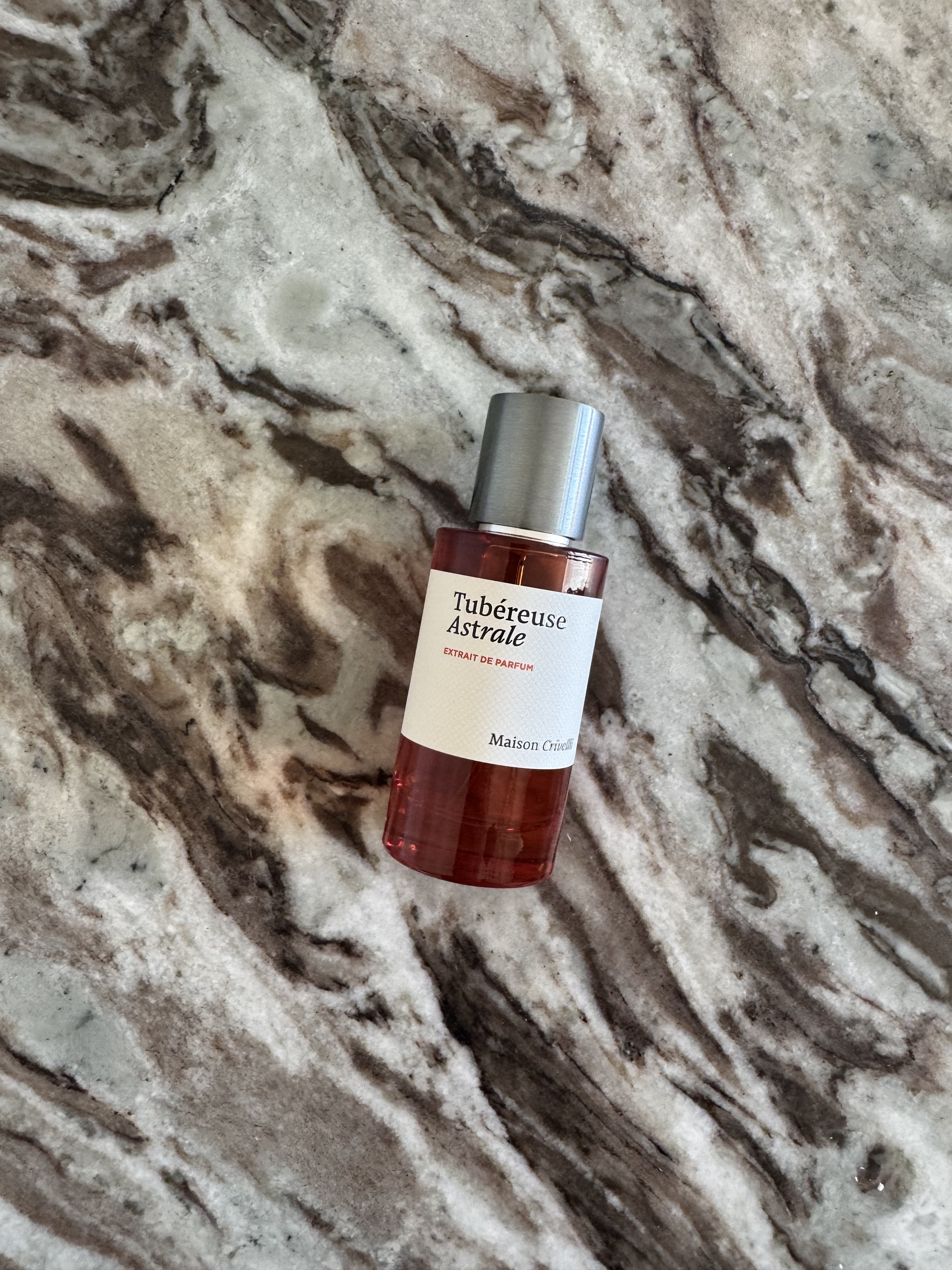 A bottle of Maison Crivelli Tub&amp;eacute;reuse Astrale on a marble table