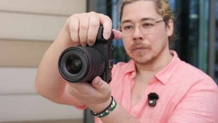 Canon EOS R6 V with the Canon RF 20-50mm f/4L IS USM PZ being held by James Artaius