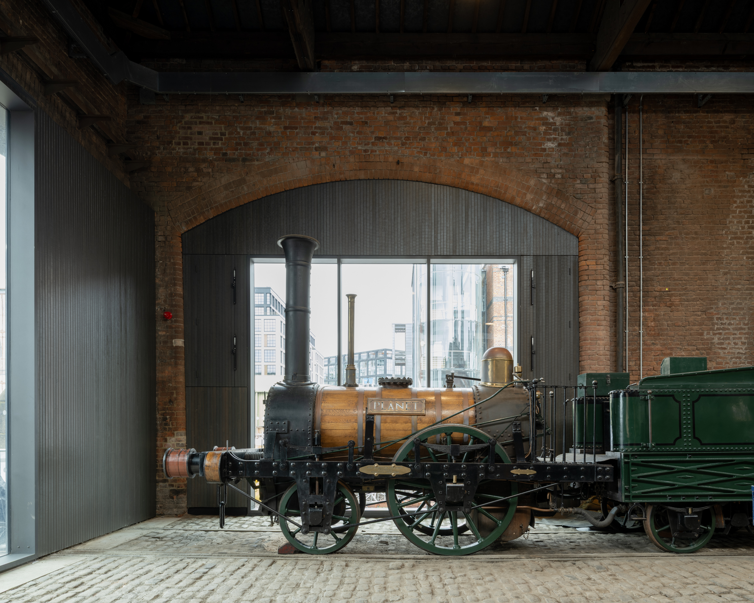 Power Hall by Carmody Groarke, a renovated warehouse with large machines, like old locomotives