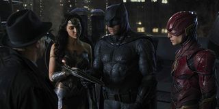 Justice League Commissioner Gordon talks with Wonder Woman Batman and The Flash on a rooftop