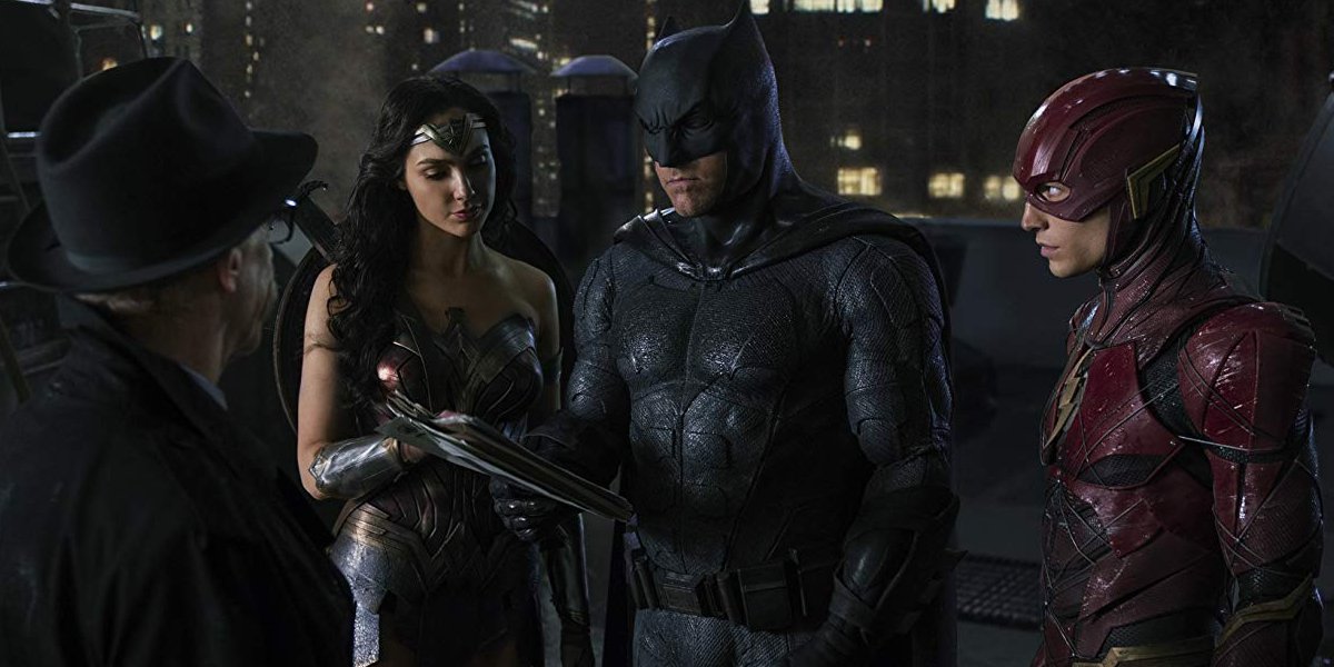 Justice League Commissioner Gordon talks with Wonder Woman Batman and The Flash on a rooftop