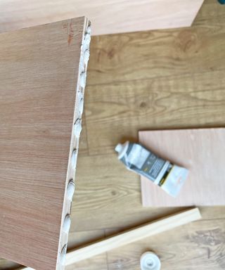 Glue dots along the edge of a piece of plywood