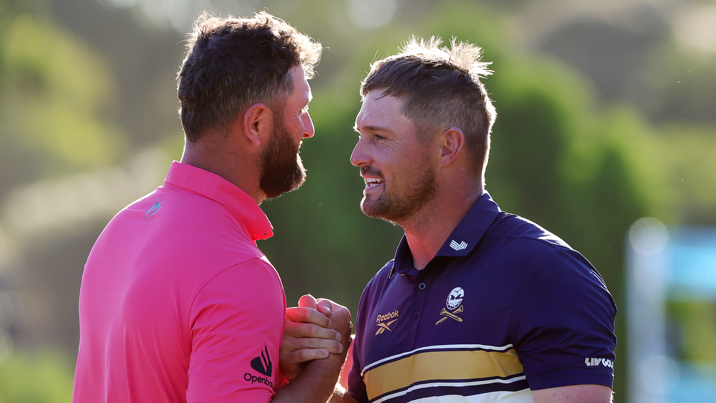 Jon Rahm and Bryson DeChambeau shake hands