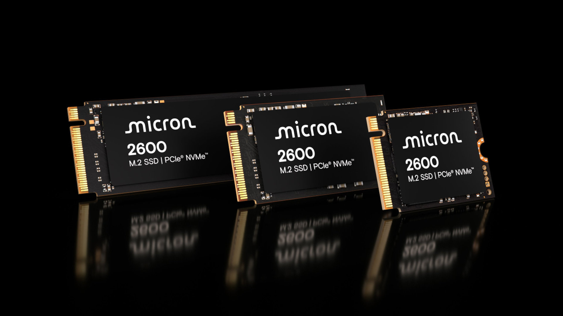 A promotional image showing a selection of Micron 2600 SSDs against a black background and dark reflective surface.