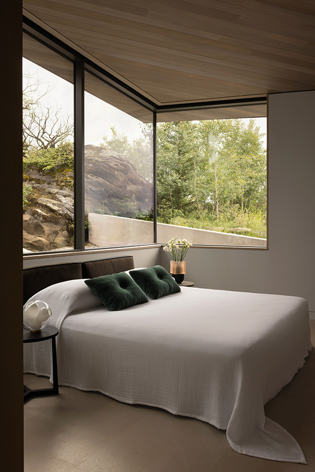 Cut Out House, a square footprint home with a round cut out set in the canadian winderness, by a lake
