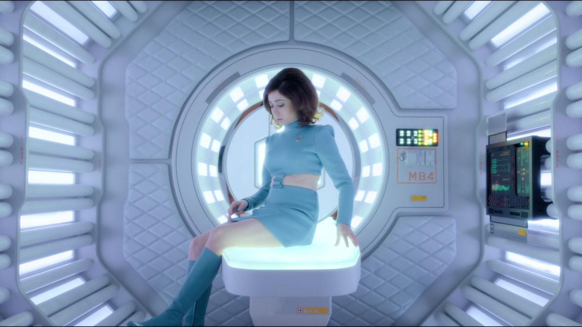 Cristin Milioti sits aboard a table on the spaceship USS Callister in Black Mirror