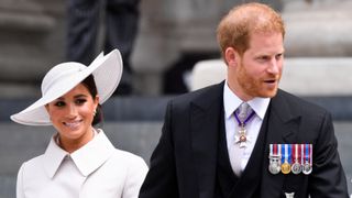 Meghan Markle and Prince Harry smiling as they leave the National Service of Thanksgiving at St Paul's Cathedral during the Queen's Platinum Jubilee celebrations on June 3, 2022 in London, England. The Platinum Jubilee of Elizabeth II is being celebrated from June 2 to June 5, 2022