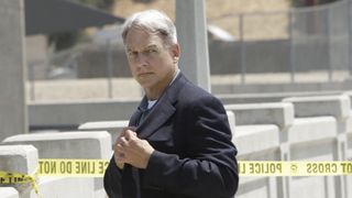 Mark Harmon as Agent Gibbs, pulling something from his blazer in NCIS