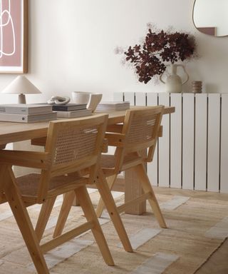 A dining area with a wooden table and chairs