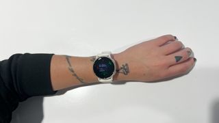Writer wearing Garmin Vivoactive 5 smartwatch close up against white background