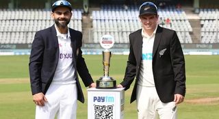 Virat Kohli of India and Tom Latham of New Zealand posing with a trophy