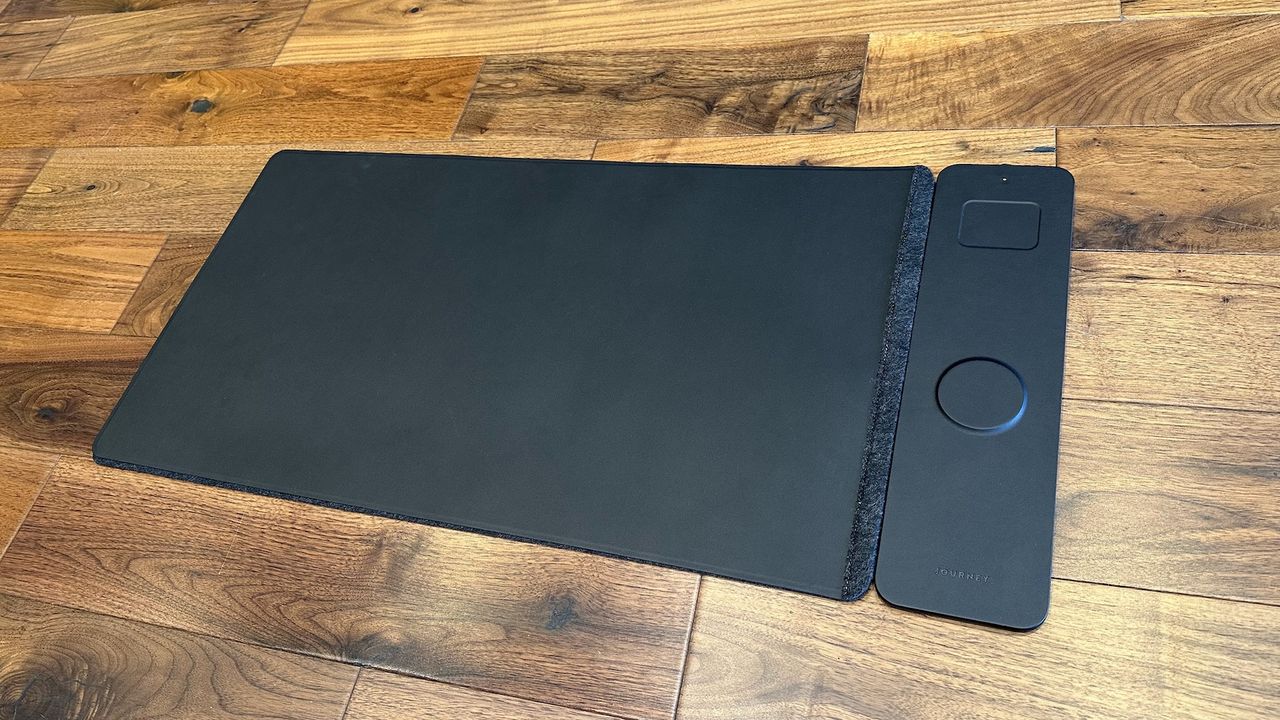 The Journey ALTI Wireless charging desk mat in a wood-lined office