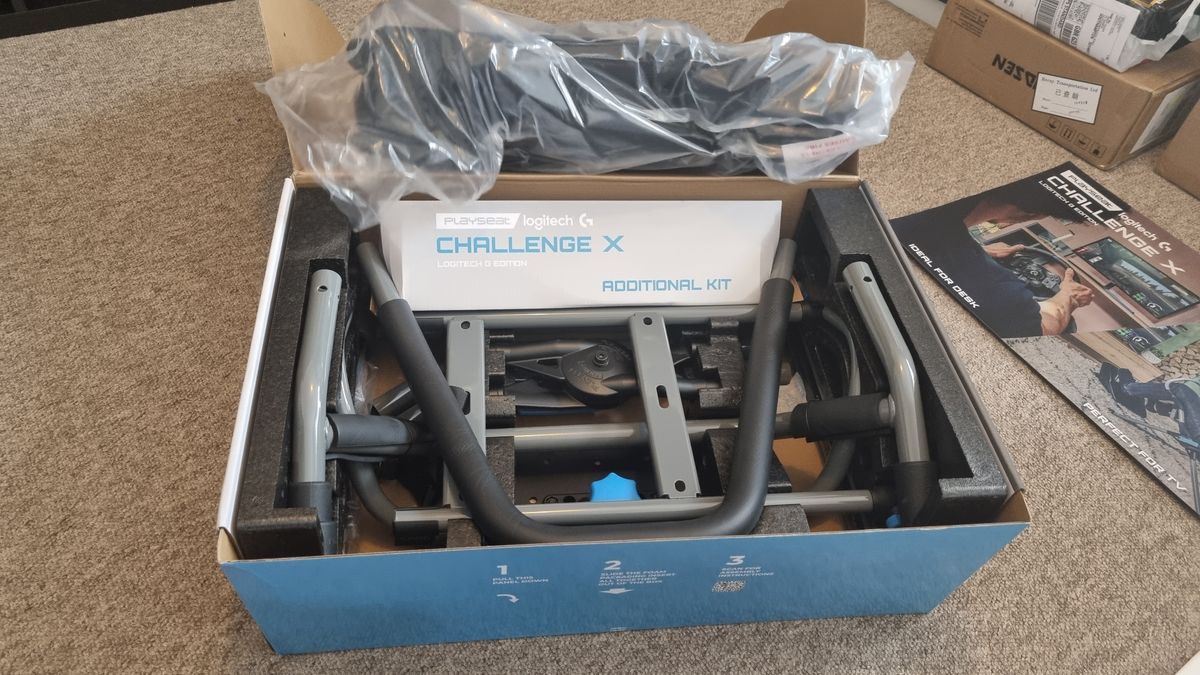 The opened Logitech Playseat Challenge X box, showing the components packaged inside