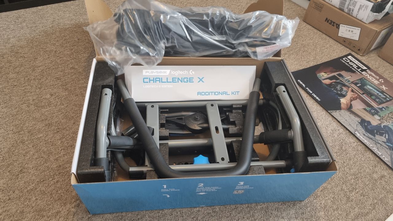 The opened Logitech Playseat Challenge X box, showing the components packaged inside