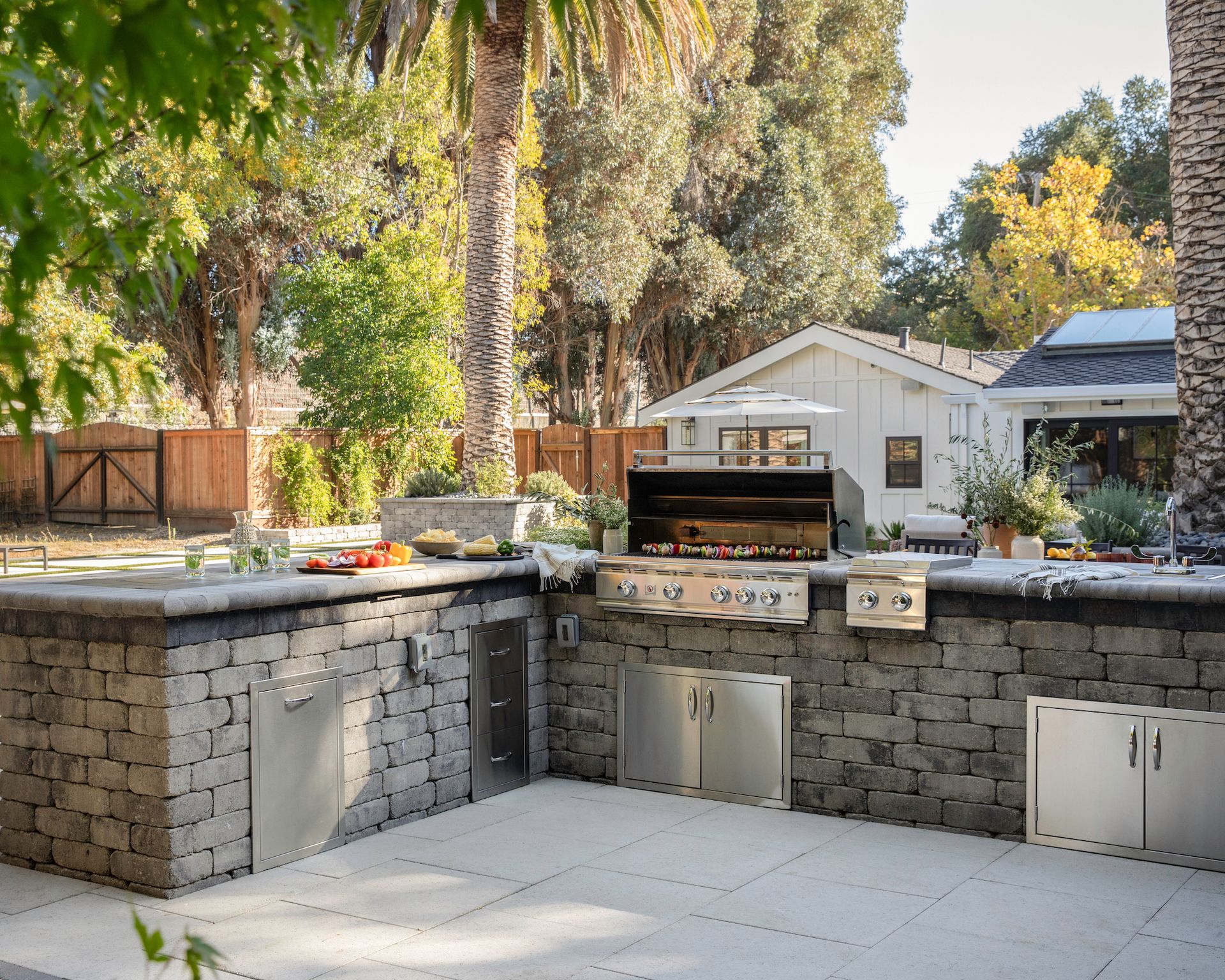 Outdoor kitchen with stainless-steel cabinets and appliances and stone finish