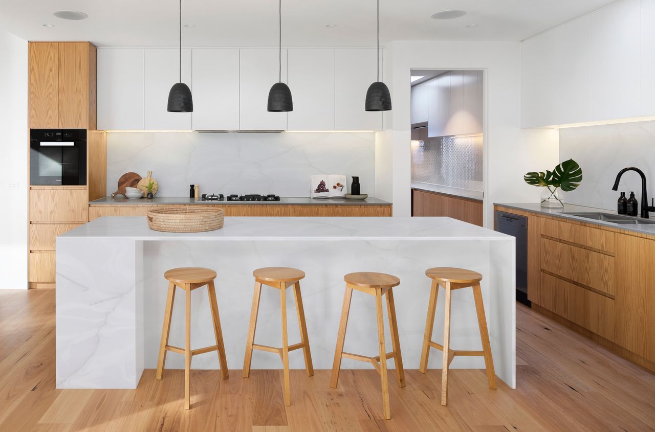 white and wood kitchen with white kitchen island/breakfast bar with wooden bar stools