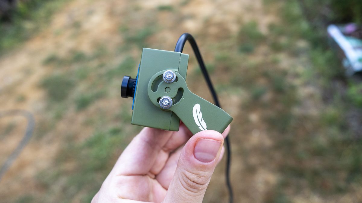 Close up of the Green Feathers TV connectable wildlife camera held in a female hand