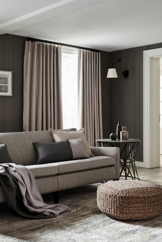 Grey living room with grey curtains and grey sofa with fabrics by James Hare