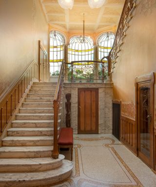 Art Nouveau entryway with staircase and large curved windows