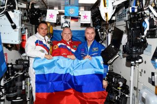 Cosmonauts hold flag