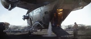 The Mandalorian unloads a cargo hold full of captured bounties, encased in carbonite.