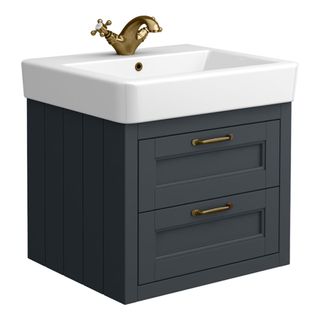 A wall-mounted small vanity unit in grey tones with brass hardware