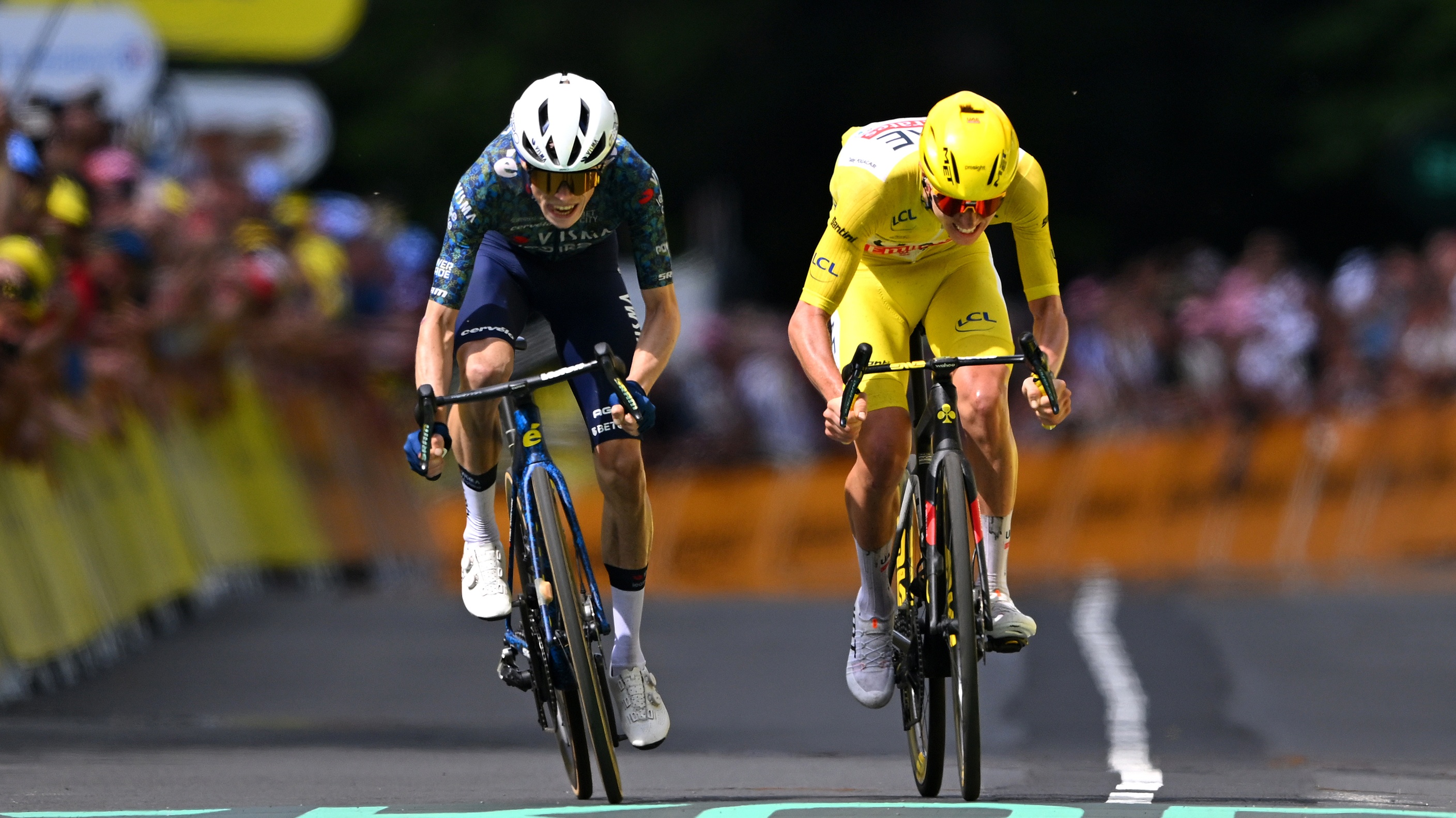 Jonas Vingegaard and Tadej Pogacar sprint to the finish line at Stage 12 of the 2024 Tour de France.
