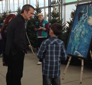 Canadian astronaut Chris Hadfield chats with a young fan at an event in Sarnia, Ont., Nov. 23, 2013.