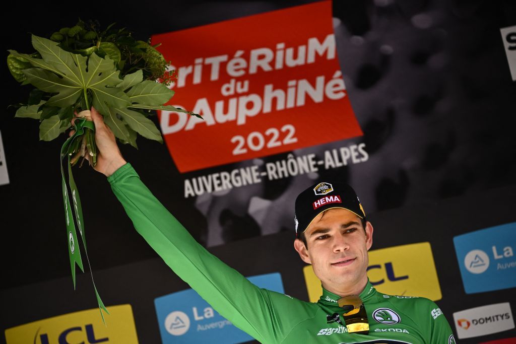 JumboVisma teams Belgian rider Wout Van Aert celebrates on the podium with the sprinters green jersey after the fourth stage of the 74th edition of the Criterium du Dauphine individual time trial cycling race 319 km between Montbrison and La Batie dUrfe central eastern France on June 8 2022 Photo by Marco BERTORELLO AFP Photo by MARCO BERTORELLOAFP via Getty Images