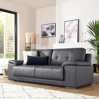 Black leather sofa in white living room