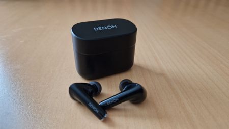 Denon Noise Cancelling Earbuds pictured next to their case