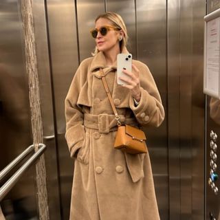 Kelly Rutherford wearing a brown Strathberry bag