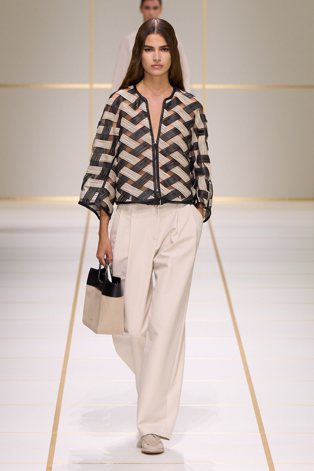 a model walks the giorgio armani s/s 27 runway.