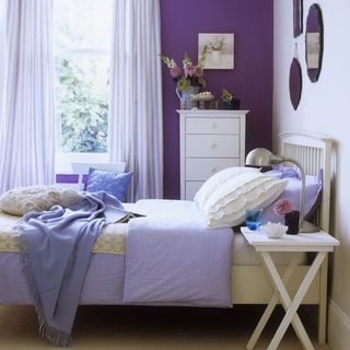 bedroom with lilac curtain and flower vase