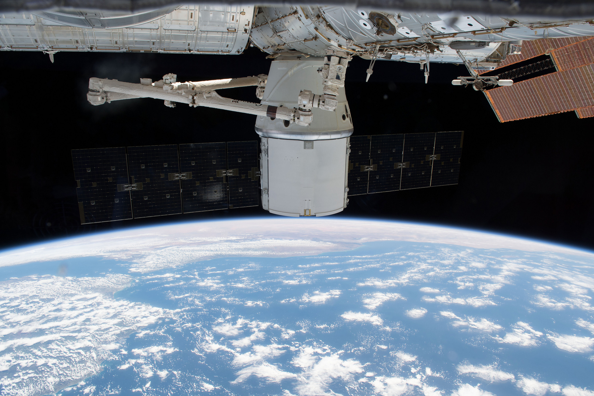 NASA and SpaceX have postponed the return to Earth of the CRS-14 Dragon cargo ship (seen here at the International Space Station) to Saturday, May 5, 2018, due to rough seas at its splashdown zone.