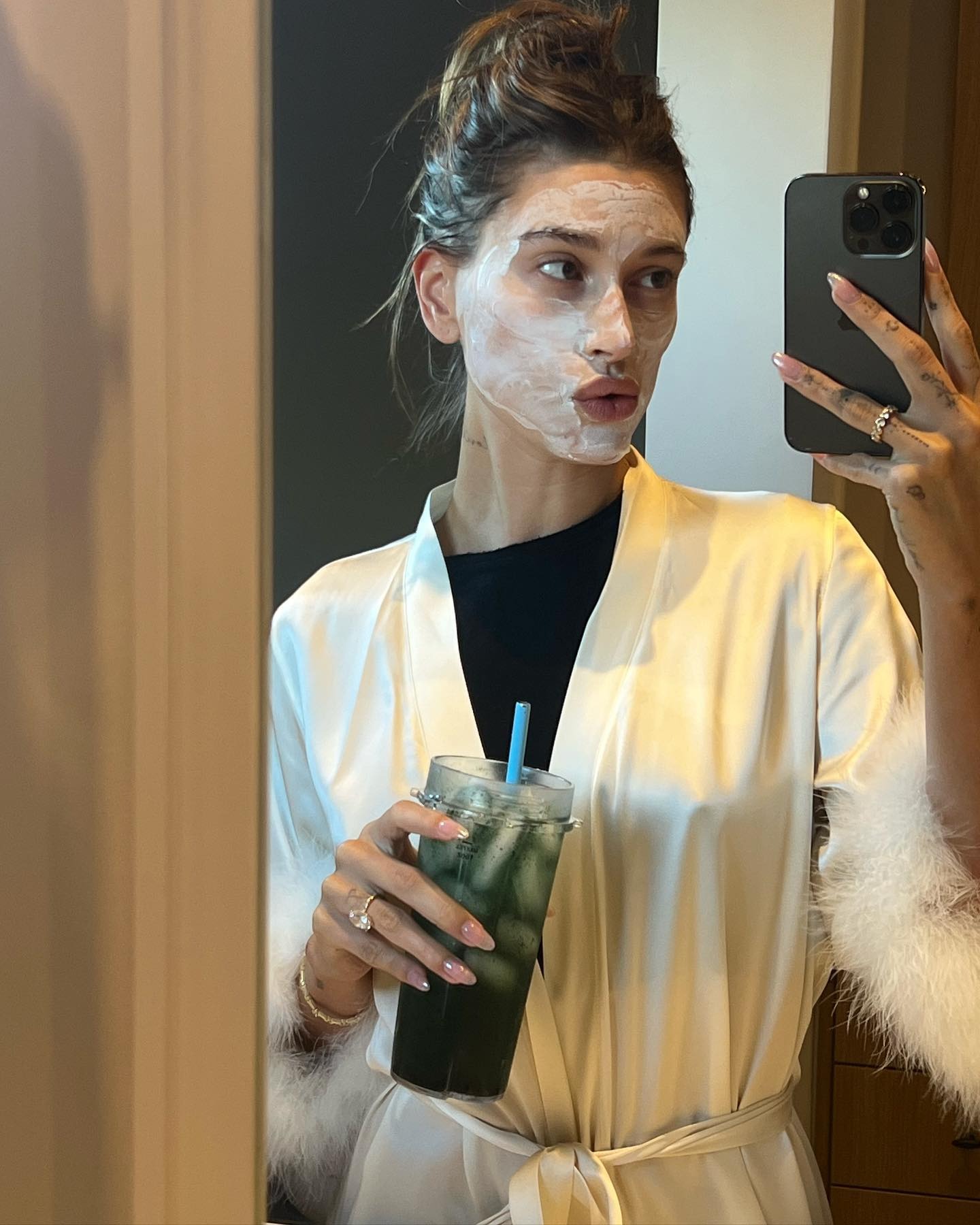 Hailey Bieber with a facial product on.