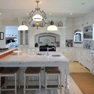 kitchen area with white wall and wooden floor and white counter