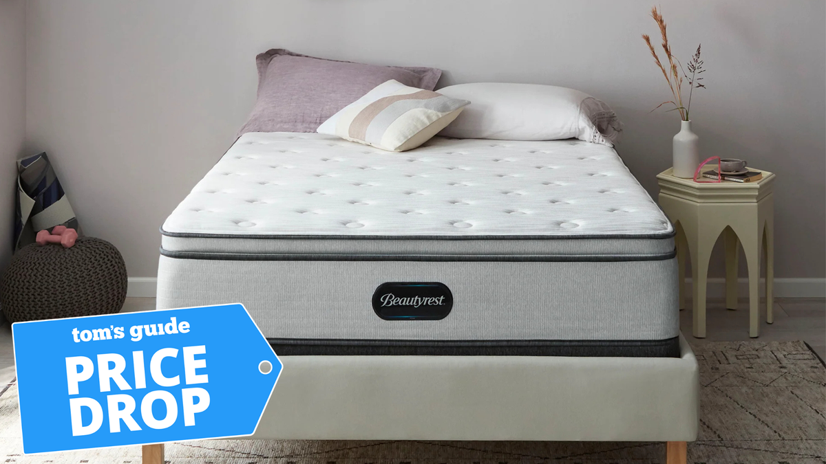 A Beautyrest BR800 13.5&quot; Plush Pillow Top mattress on a bed base in a bedroom