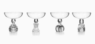 Four champagne coupes in clear crystal with thick engraved bases