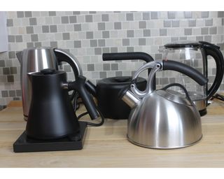 A collection of the best tea kettles being testing in a kitchen