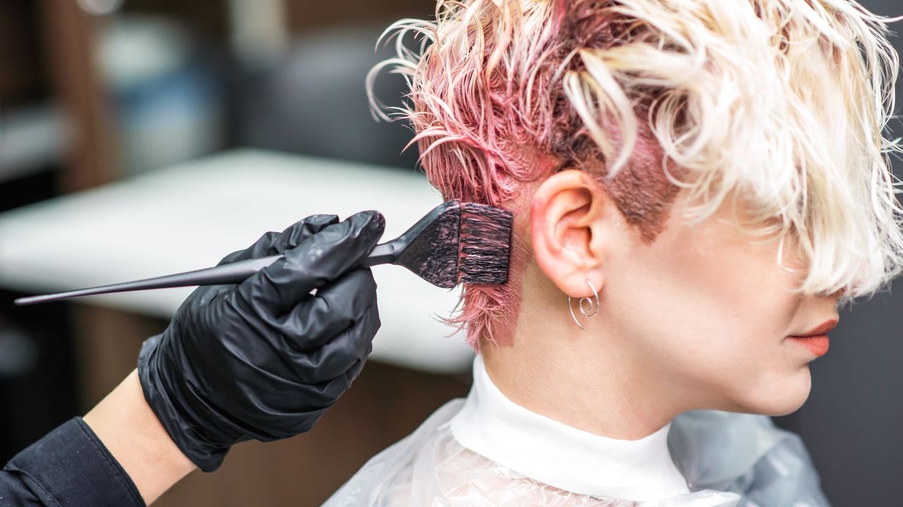 woman getting her hair colored blonde with foil at los angeles salon