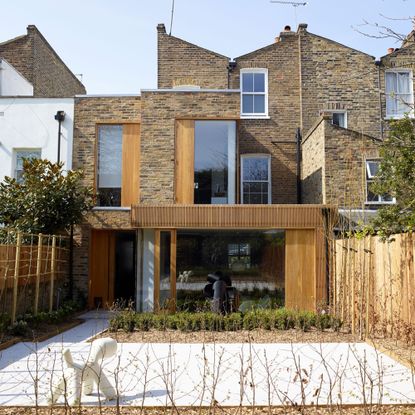 Two storey modernist extension with brick and cladding