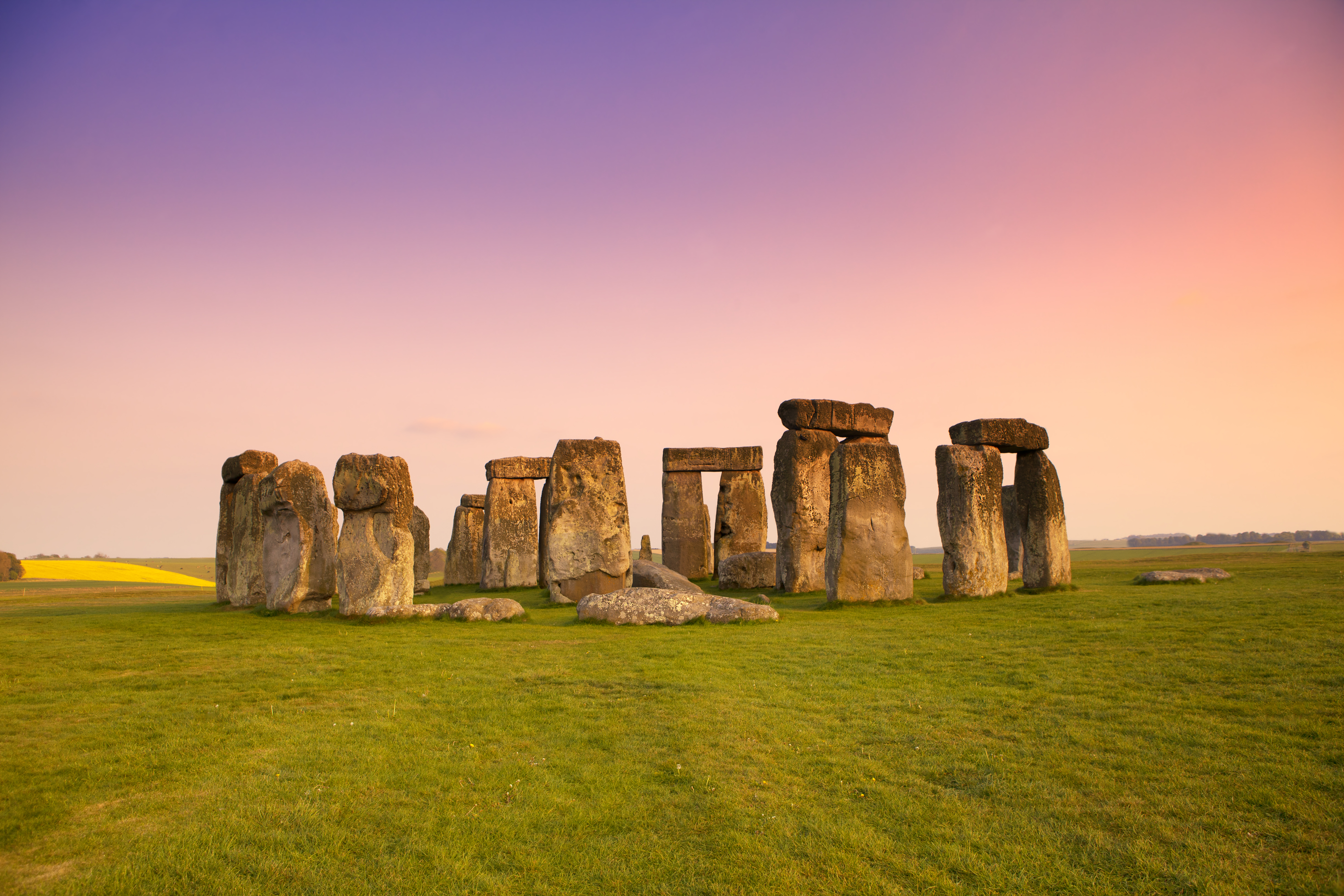 Ancient stones at Stonehenge, Wiltshire. Dramatic sky and golden hues of dusk.