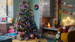 green living room with bold rainbow bright Christmas tree decorating idea with matching bauble wreath on the wall