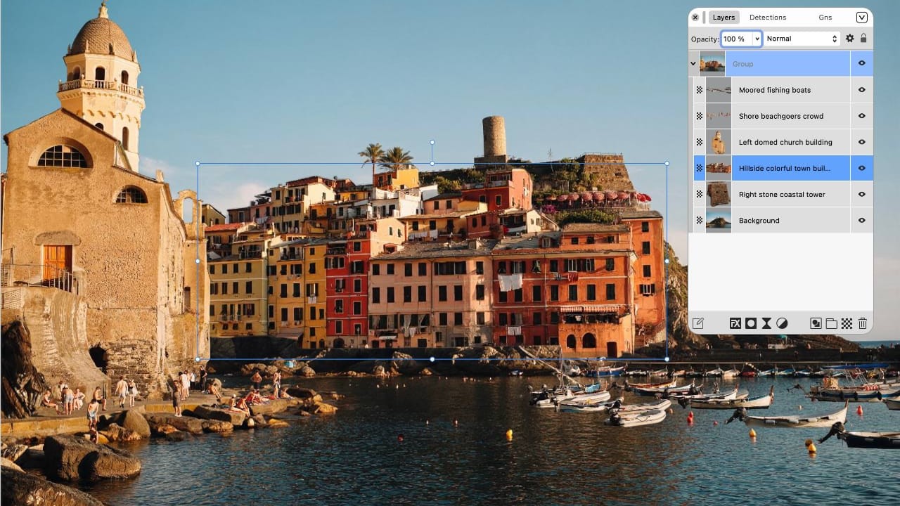 A photo-editing interface showing a coastal Italian town with a layers panel listing separated elements including moored fishing boats, a beachgoers crowd, a domed church and a hillside building.
